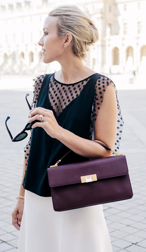Black sleeveless top with sheer polka dot overlay and white skirt.