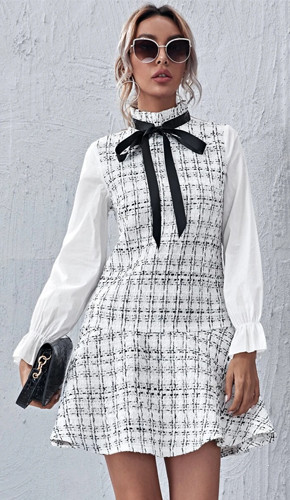 White a-line dress with plaid pattern, frill and tie front.