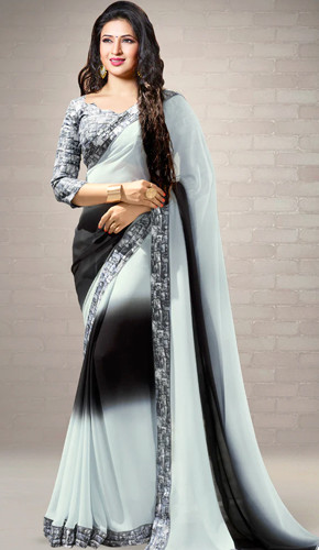 White and black printed saree with designer border, worn with matching blouse.
