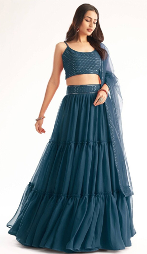 Stunning designer blue lehenga choli in bollywood style. crafted from faux georgette, adorned with foil mirror and intricate embroidery work. sleeveless with spaghetti straps, perfect for diwali celebrations.