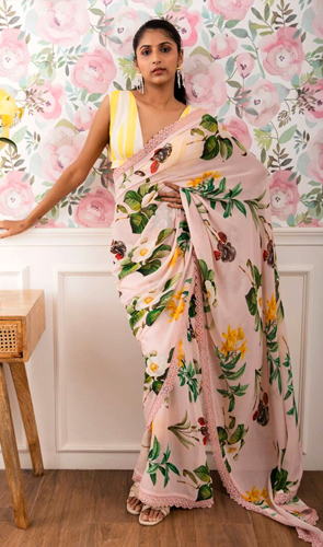 Elegance in pink! adorn yourself with this georgette saree featuring floral printed motifs, gracefully complemented by a striped, sleeveless blouse with a deep v-neck.