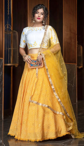 Bright yellow cotton lehenga with foil printed and sequence embroidery work, paired with a net dupatta. Bright yellow cotton lehenga with foil printed and sequence embroidery work, paired with a net dupatta.