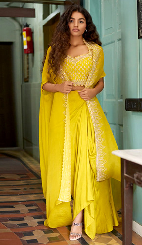 Mustard yellow embroidered cape and skirt set with cutdana and sequins details. Mustard yellow embroidered cape and skirt set with cutdana and sequins details.
