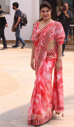 Jacqueline fernandez's hand-painted orange and white saree is perfect for the spring season. the ombre effect and intricate embroidery add ethnic charm