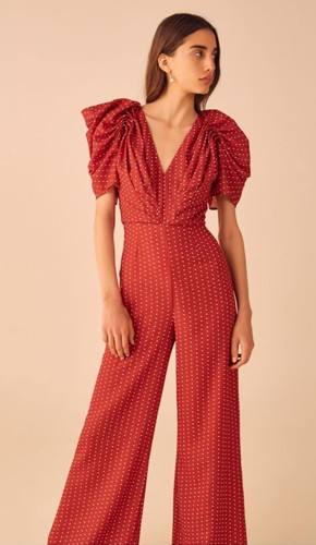 Monochrome jumpsuit with a twist in red color, deep v-neck, puff sleeves, and scattered white tiny dots. Monochrome jumpsuit with a twist in red color, deep v-neck, puff sleeves, and scattered white tiny dots.