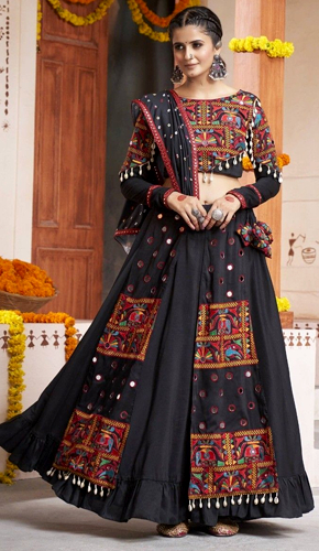 Stunning black mirror work lehenga choli set in soft rayon fabric for navratri festivities. Stunning black mirror work lehenga choli set in soft rayon fabric for navratri festivities.