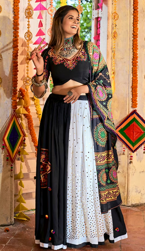 Exquisite black cotton lehenga choli set with thread embroidery, mirror, pompom, and aari work dupatta. Exquisite black cotton lehenga choli set with thread embroidery, mirror, pompom, and aari work dupatta.
